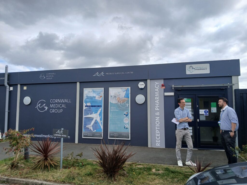 People standing outside a medical centre.
