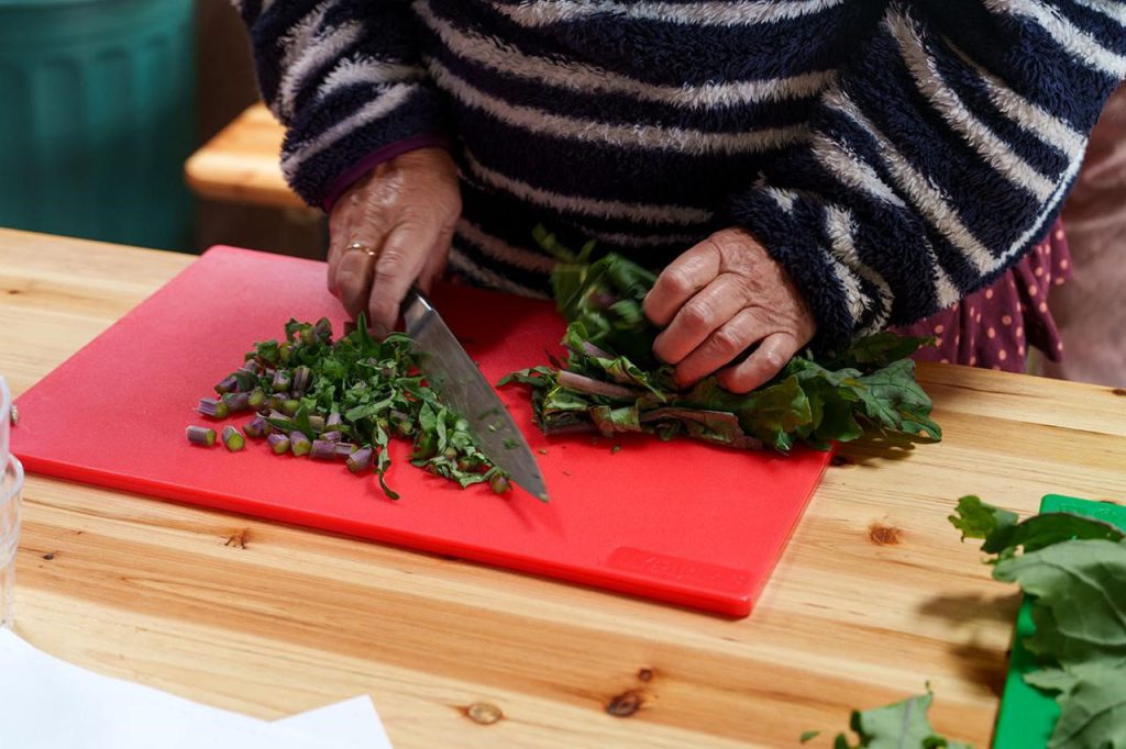Person chopping chard.